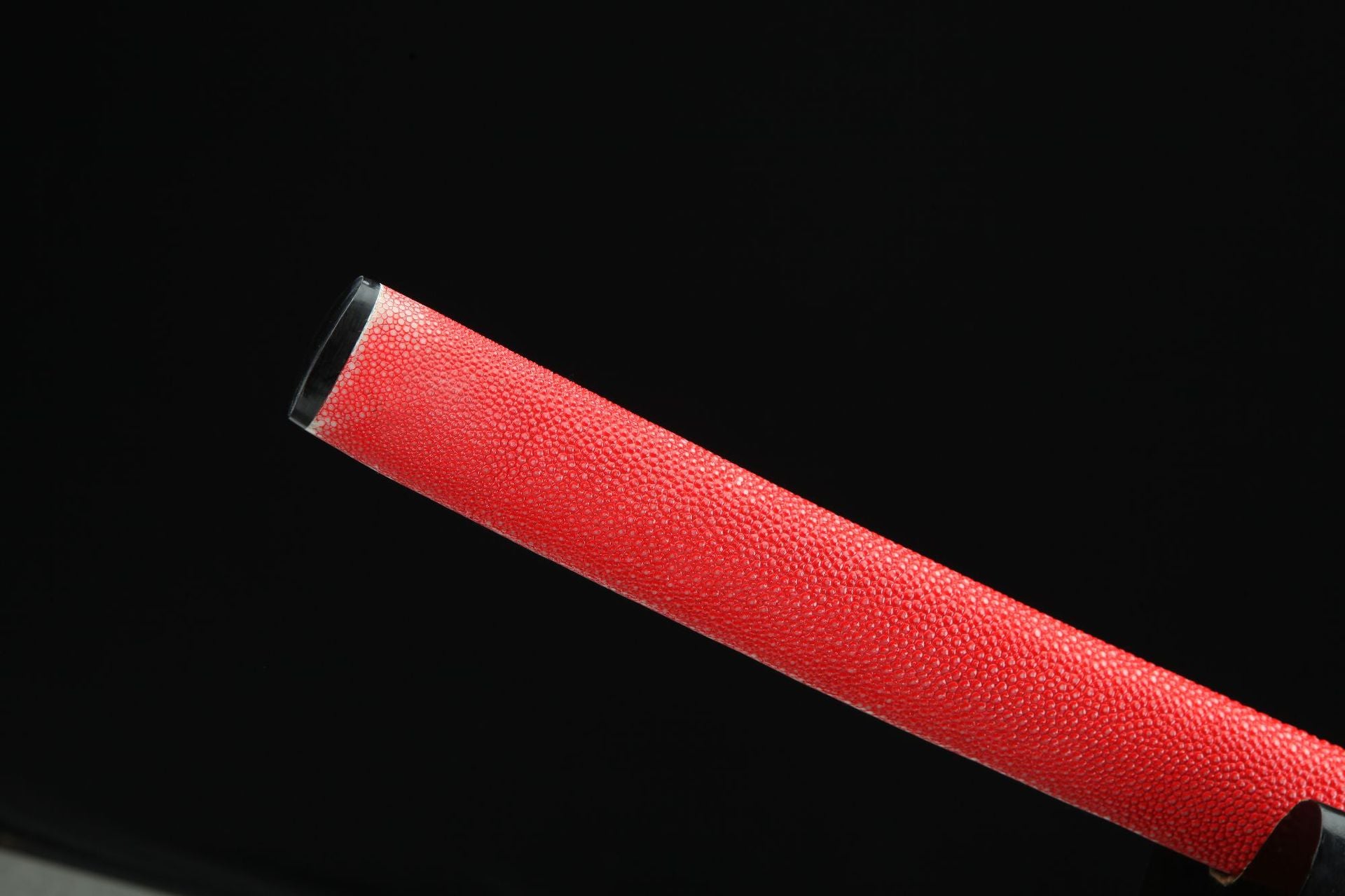 Close-up of the red ray skin scabbard (saya) of sakura ryu katana, showcasing the genuine texture and vibrant color.
