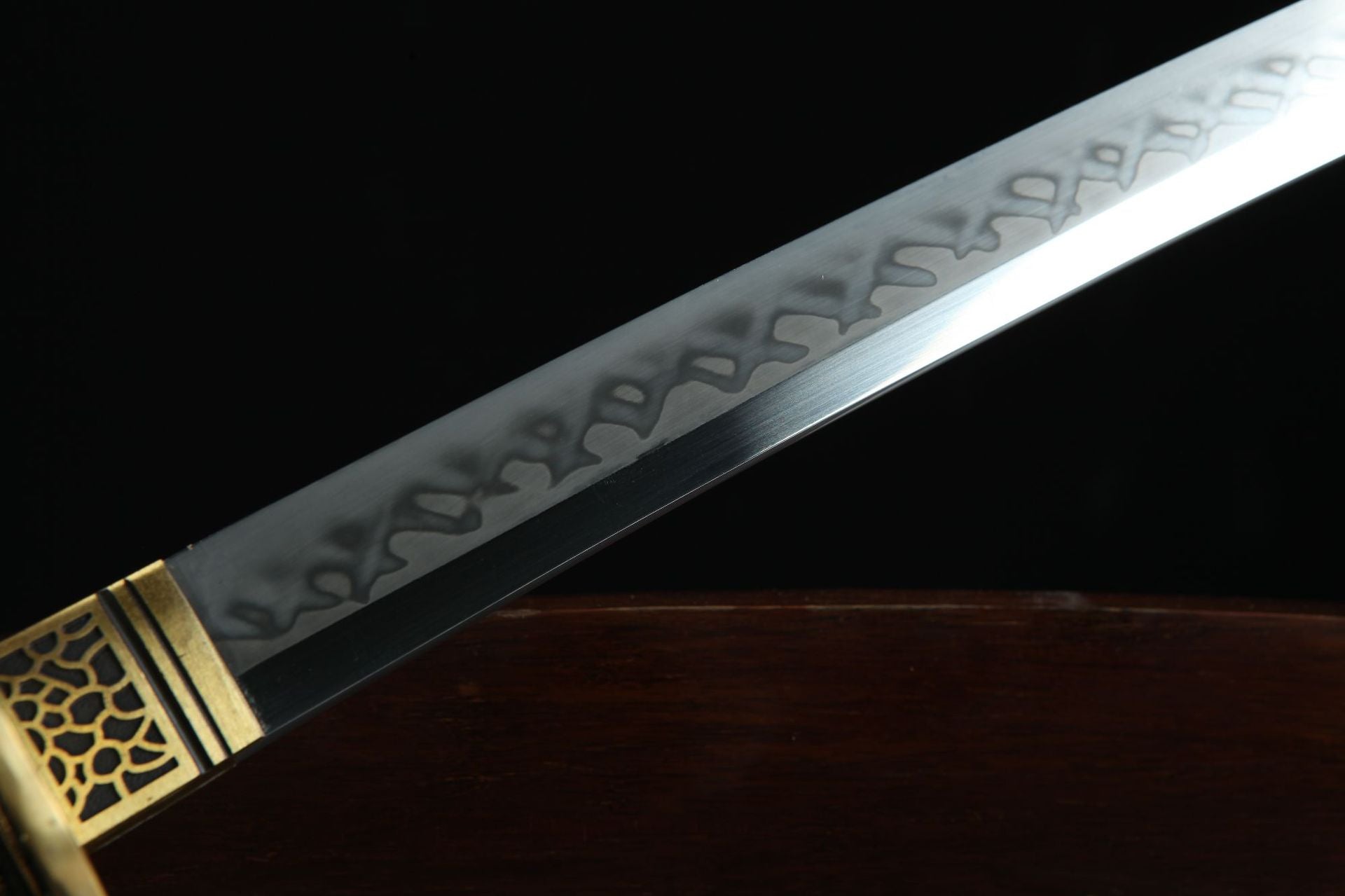 Closeup of Sakura X katana blade showing distinct hamon and polished edge.