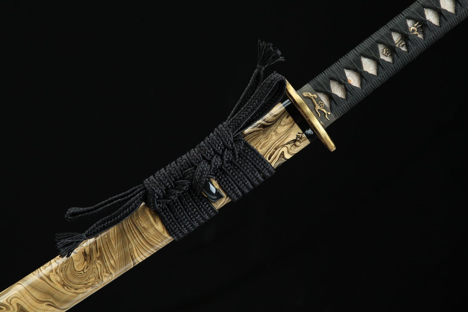Close-up of the Sakura X katana saya with intricate black cord wrapping and brass fittings.