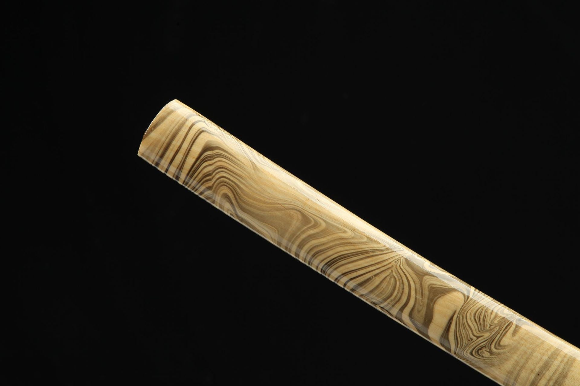 Close-up of the tip of the Sakura X katana saya with beautiful marbled wood pattern.