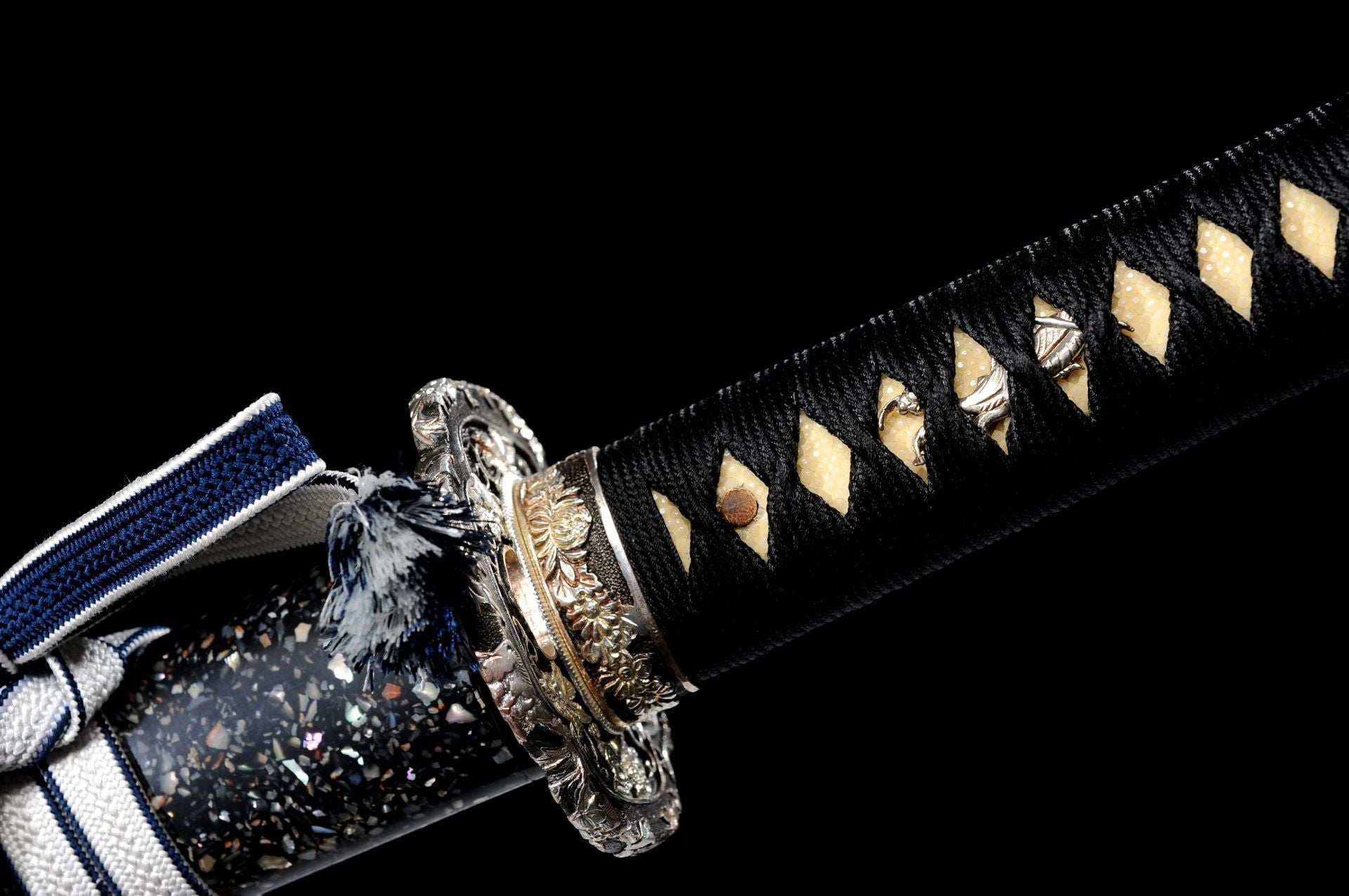 Silver-plated mekugi on the katana handle.