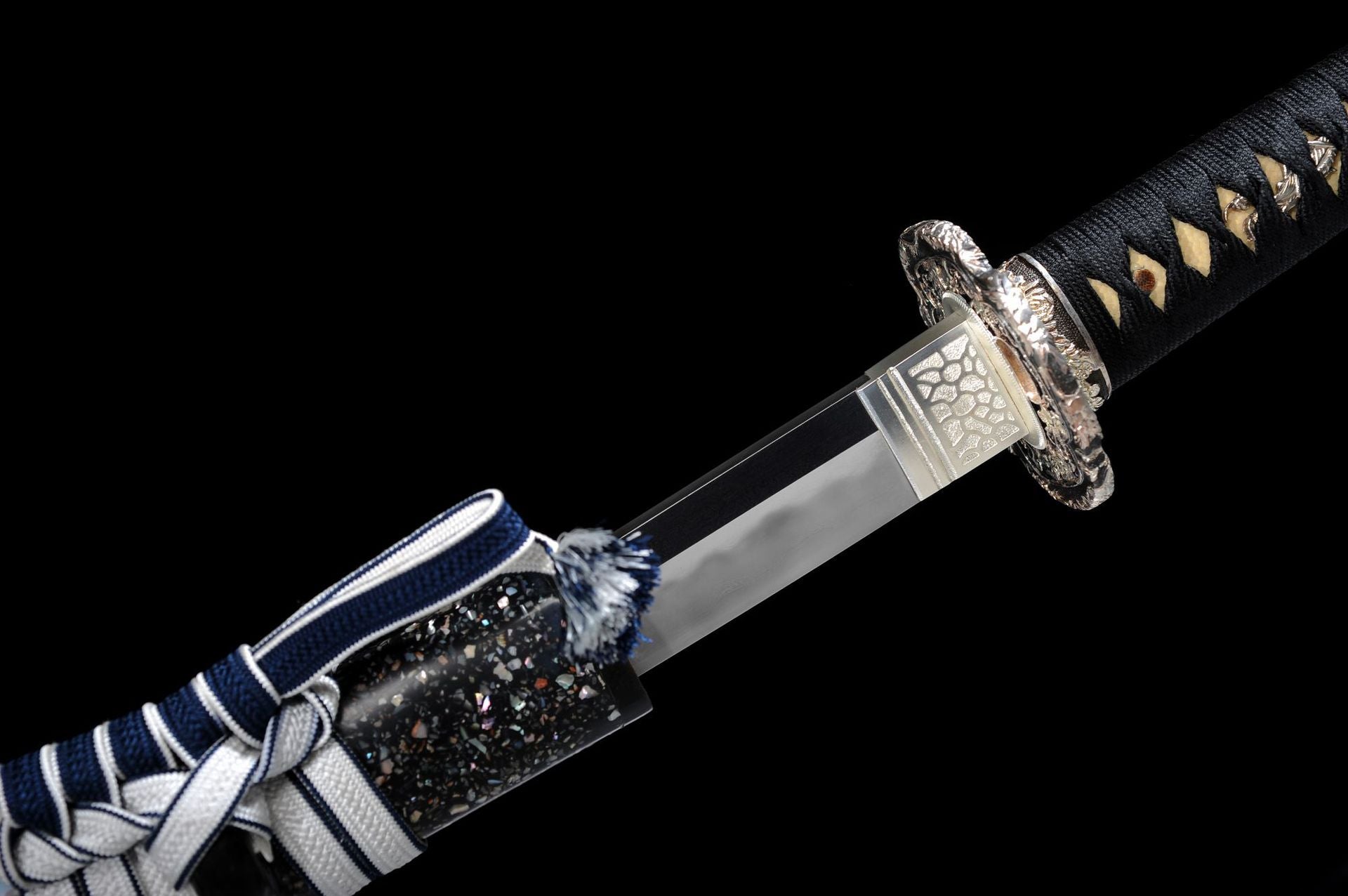 Silver habaki on a black katana.