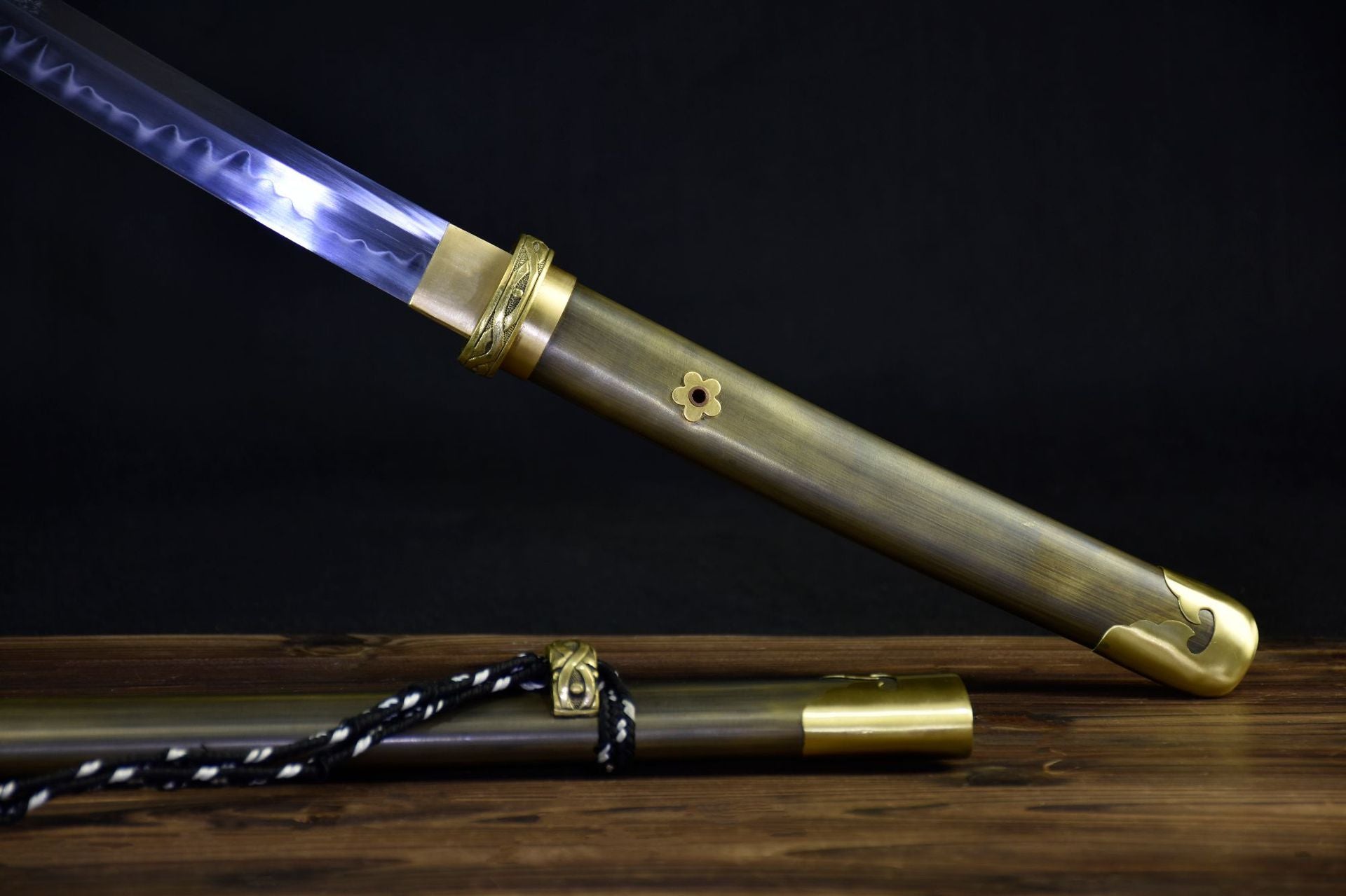 A simple wooden katana handle paired with minimalist copper fittings, highlighting a clean and functional design.