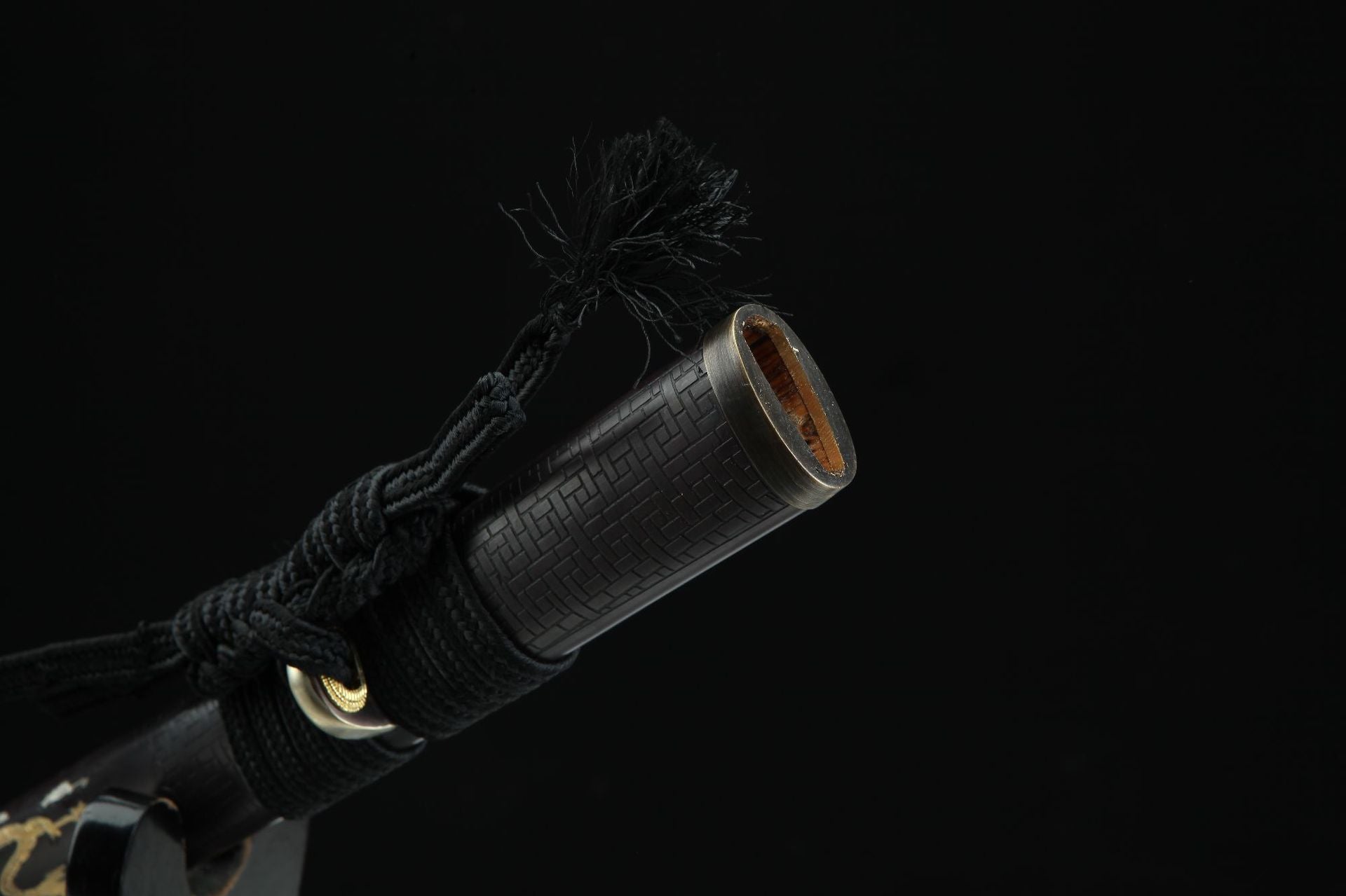 Close-up view of the Ssangyong katana's copper koiguchi, the protective and ornamental collar at the opening of the saya.
