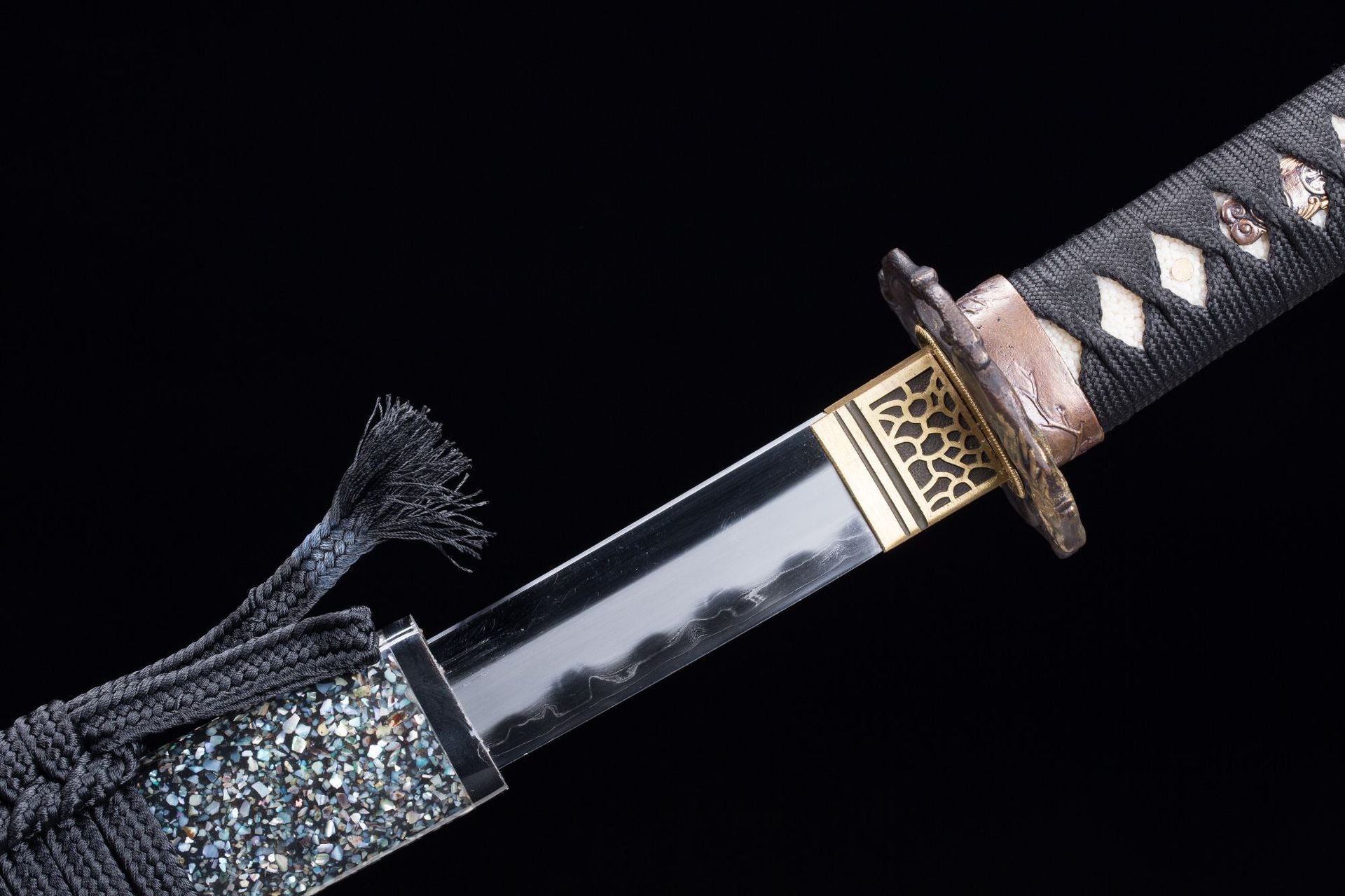 Detailed view of the Wild Horse samurai sword's fuchi and habaki.