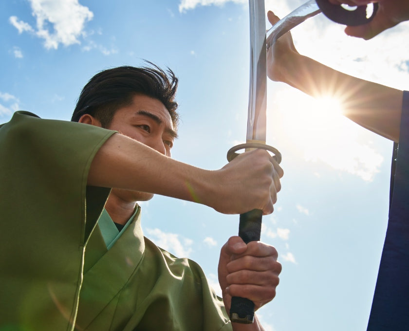 a person holding a katana