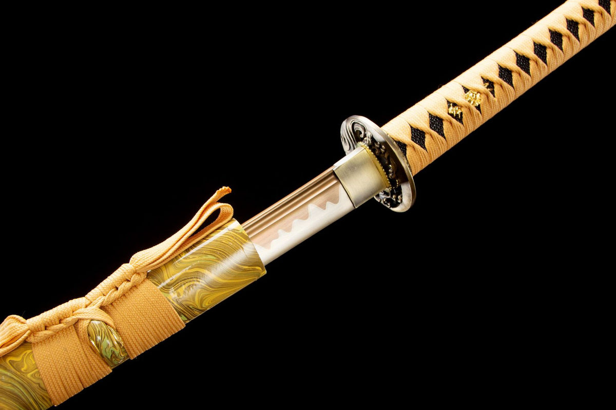 Detail view of the Golden Pearl Katana, showing the pale engraved blade and gold handle