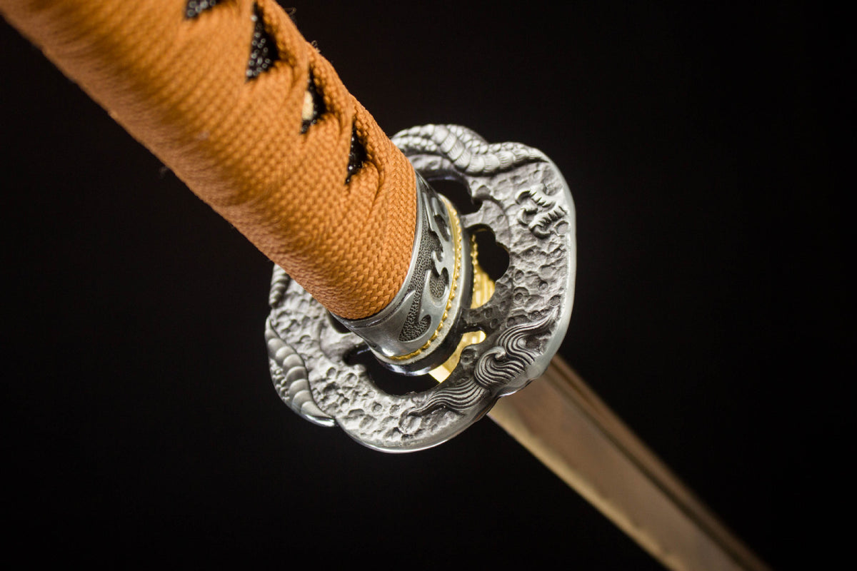 Dragon-themed alloy guard and tan cord-wrapped handle
