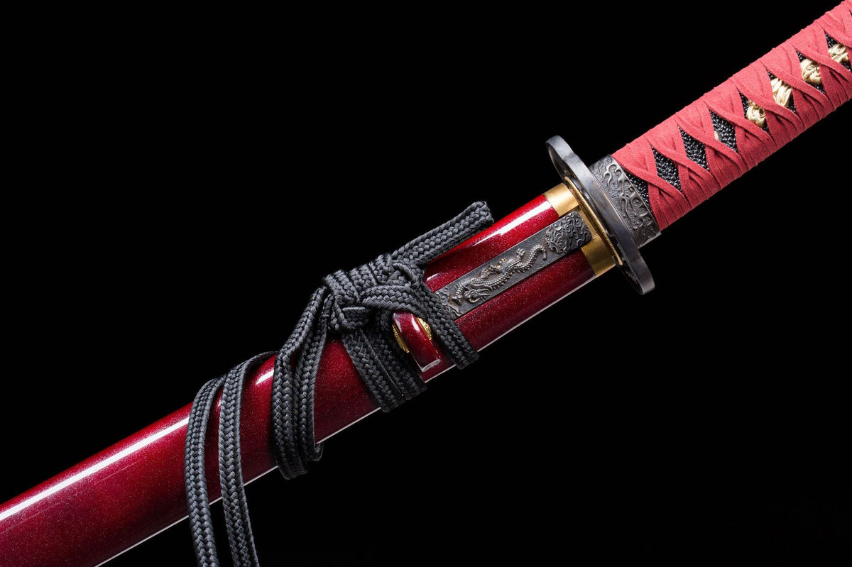 Dark and gold fitting detail beside the red lacquer saya