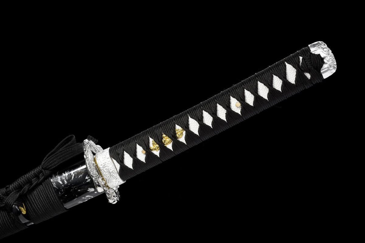 Silver-toned pommel over black cord-wrapped handle