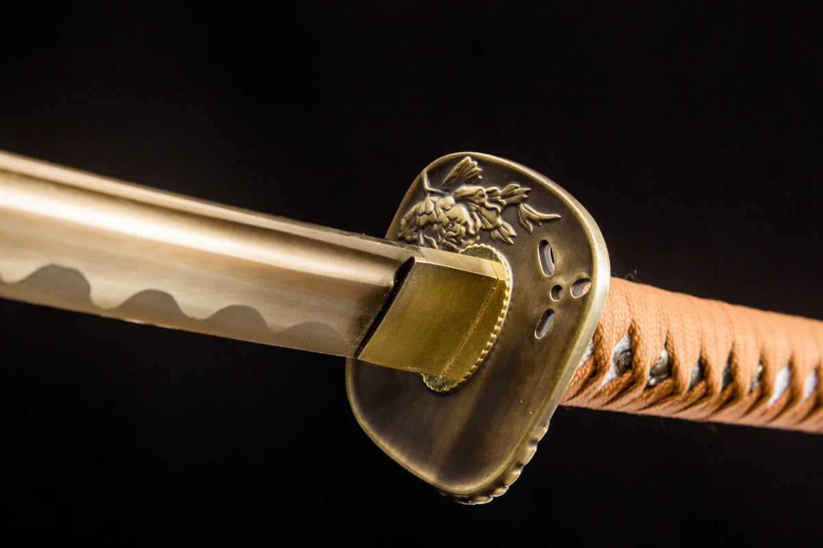 The Sakura in Gold Katana, showing the black-and-orange saya with sakura motif