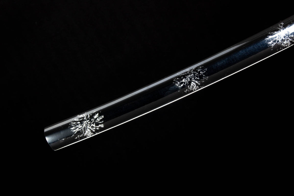 Close-up detail of the Inkstorm Katana, including the glossy black saya with silver floral motifs
