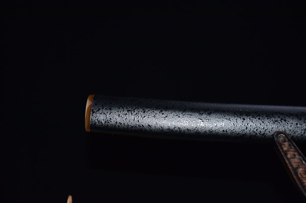 Horn kojiri on the black lacquered wood saya