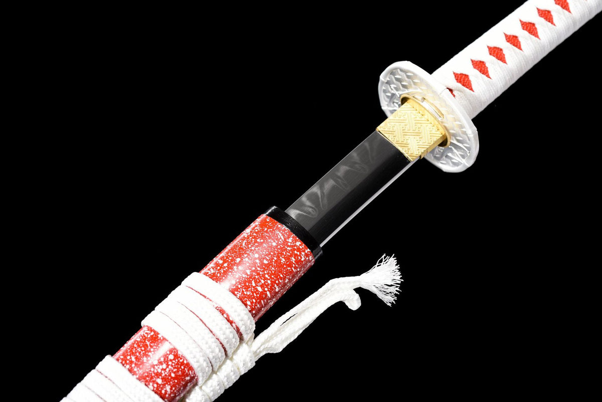 Close view of the patterned blade collar, tsuba, and red speckled saya
