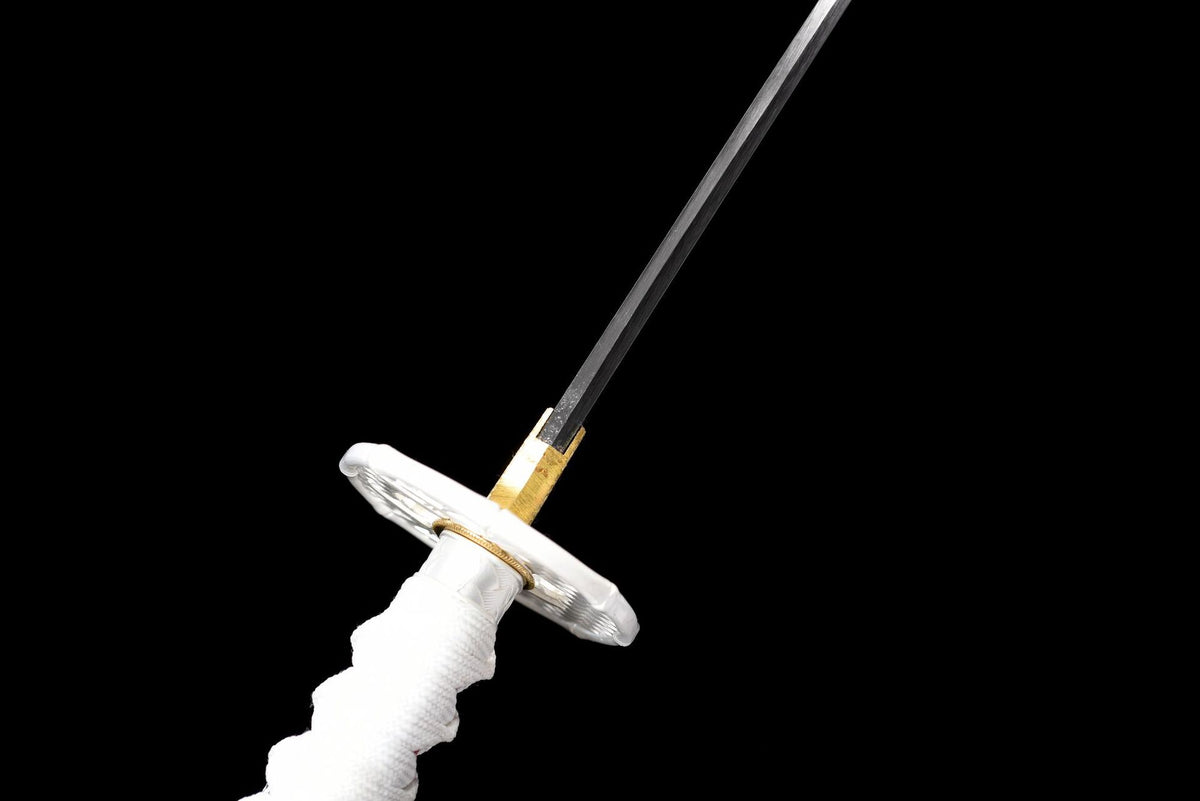 Close view of the white and silver-colored tsuba, gold-toned collar, and black blade