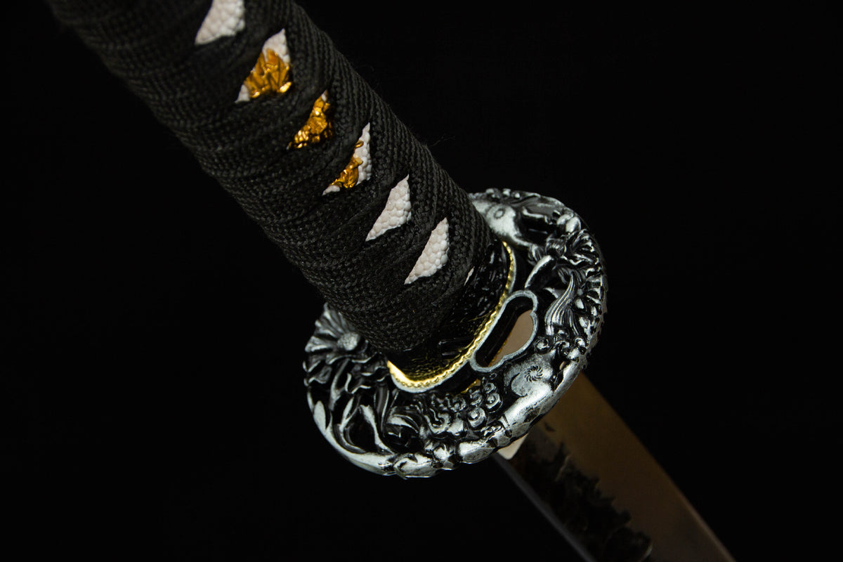 Detail view of the Autumn Mist Katana, showing the pale patterned saya and black handle