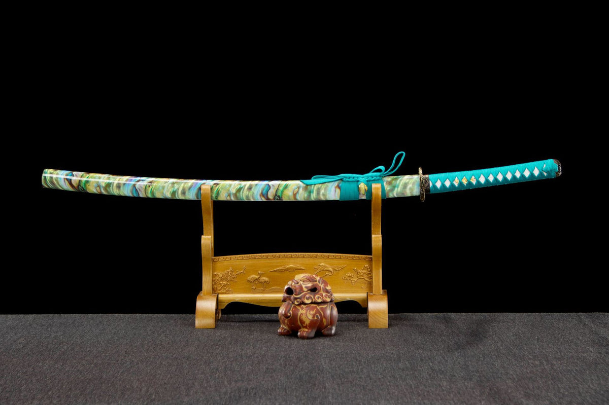Turquoise Pearl Katana displayed sheathed with a turquoise handle and marbled green saya