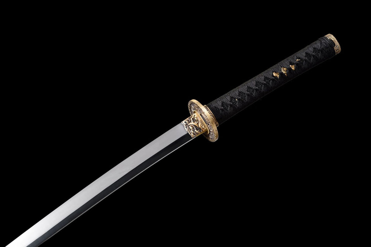Close-up detail of the Twin Dragons Katana, including the dark handle wrap and carved fittings
