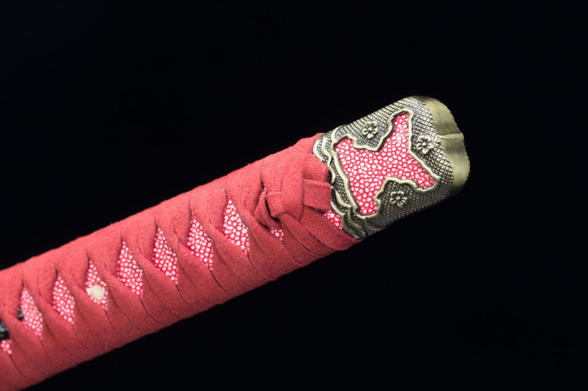 Close-up of the Raijin Katana’s red handle wrap, textured grip, and ornate end fitting