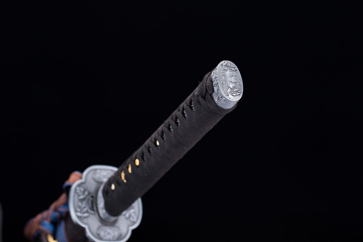 Close-up of the Kusabimaru Katana’s black handle wrap, floral guard, and end fitting