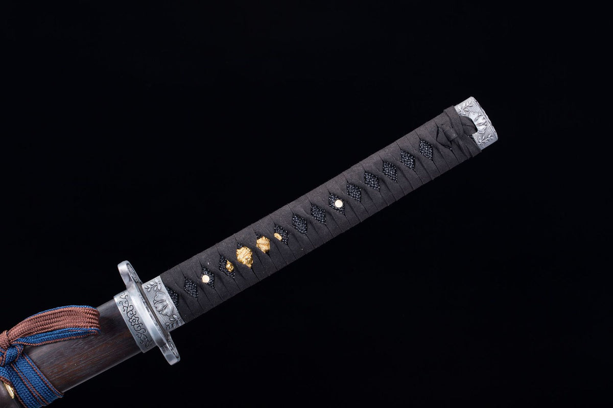 Close-up of the Kusabimaru Katana’s black handle wrap with silver fittings and rosewood saya