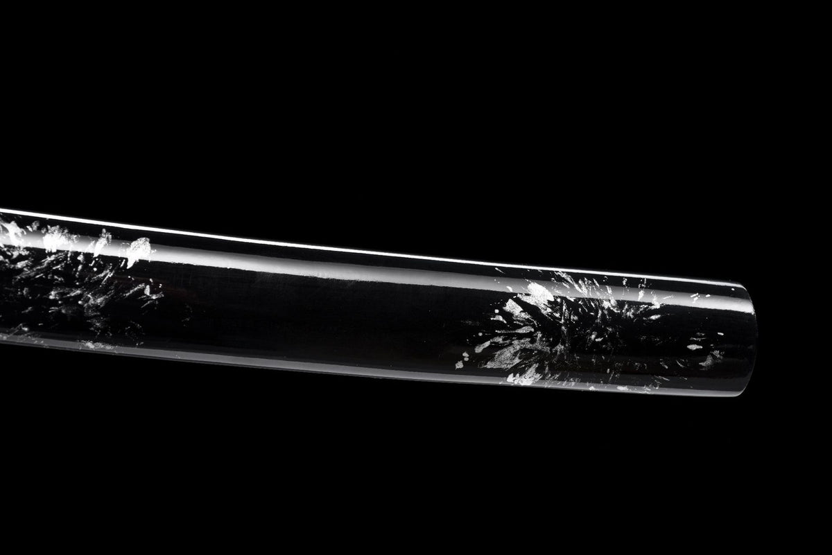 Double-dragon guard beside silver flecked black scabbard