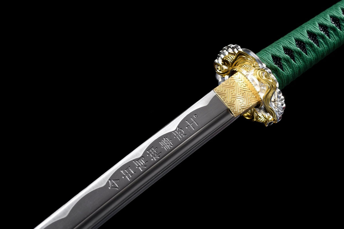 Engraved katana blade beside gold-tone habaki and openwork tsuba