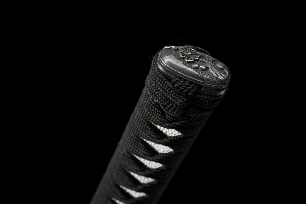 Close-up of Kuro Katana decorative pommel and black cord-wrapped handle