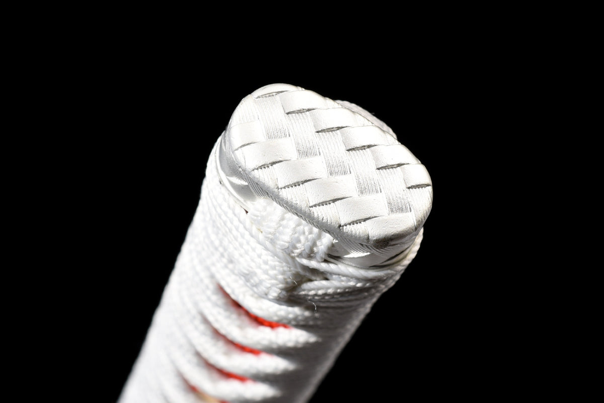 Close view of the white wrapped handle end with red accents
