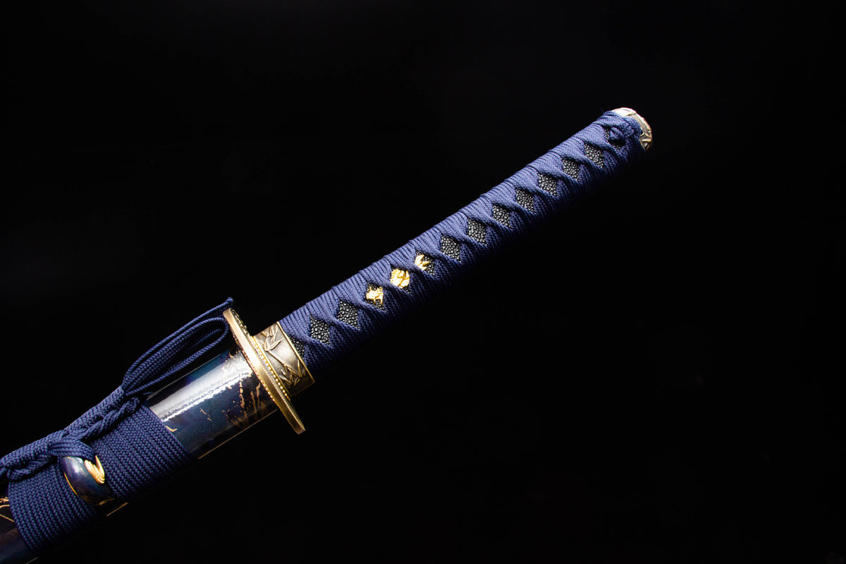 Close-up of the Midnight Studwork Katana’s studded blue handle wrap, gold fittings, and blade collar