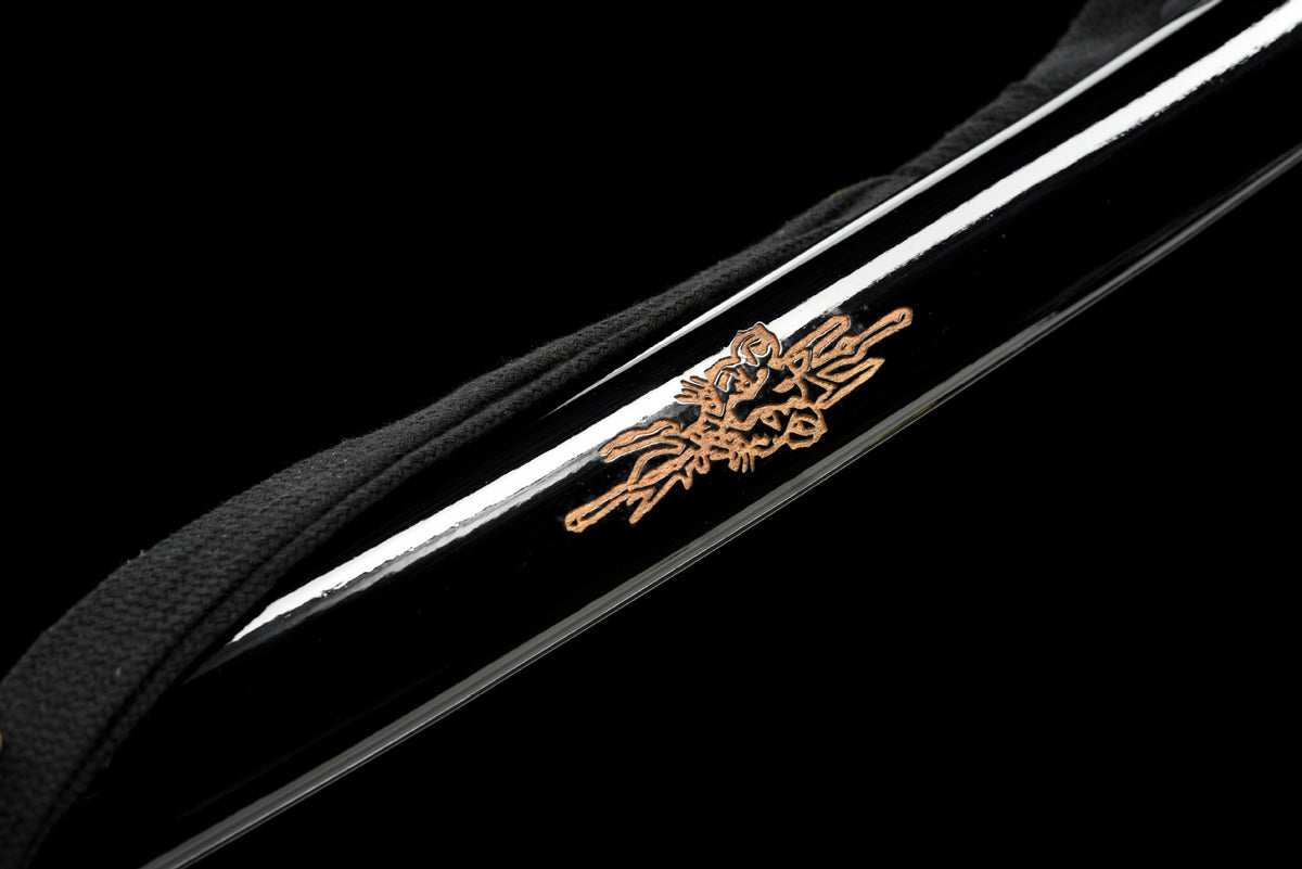 Gold-toned dragon motif on the carved black lacquered saya