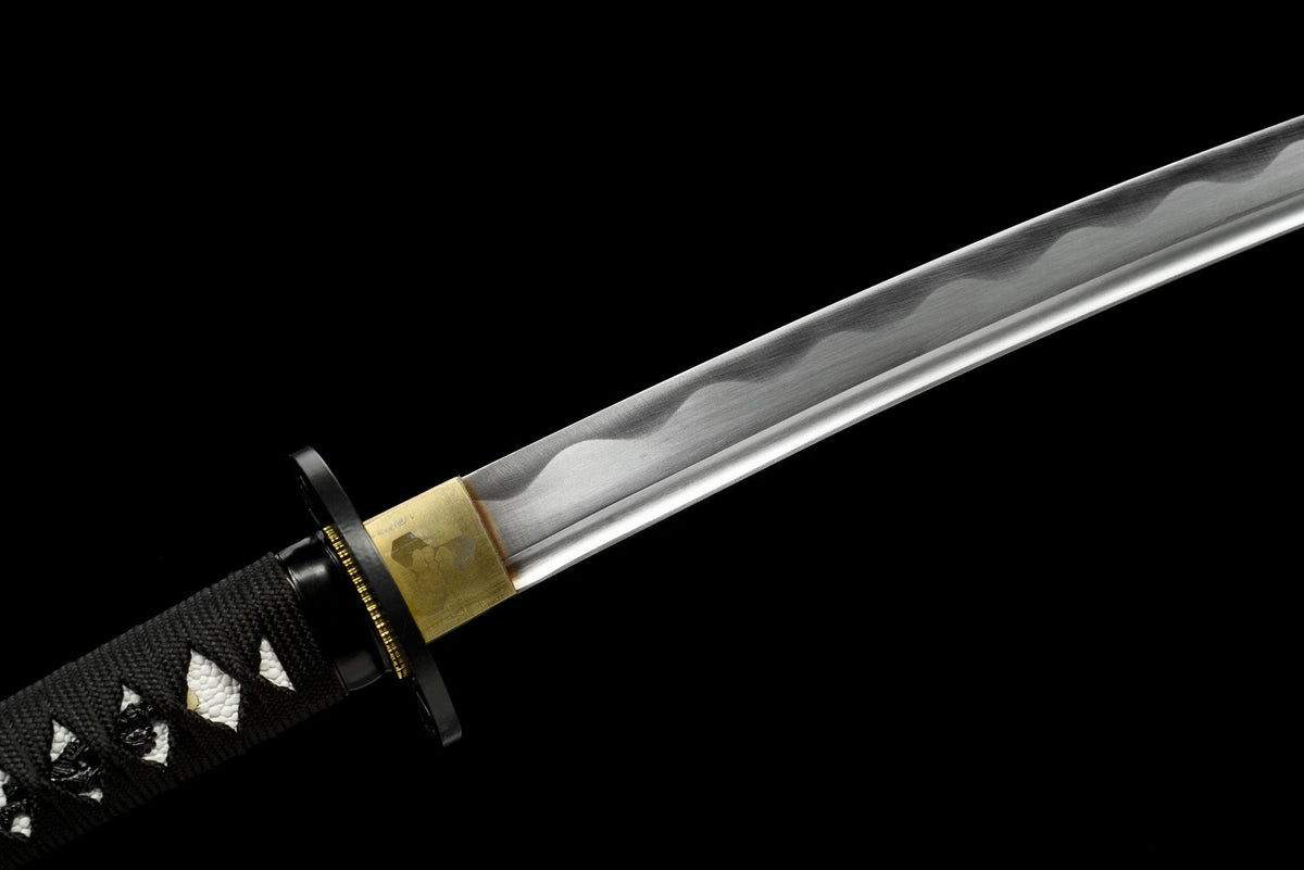 Polished blade, gold-toned habaki, and black openwork tsuba