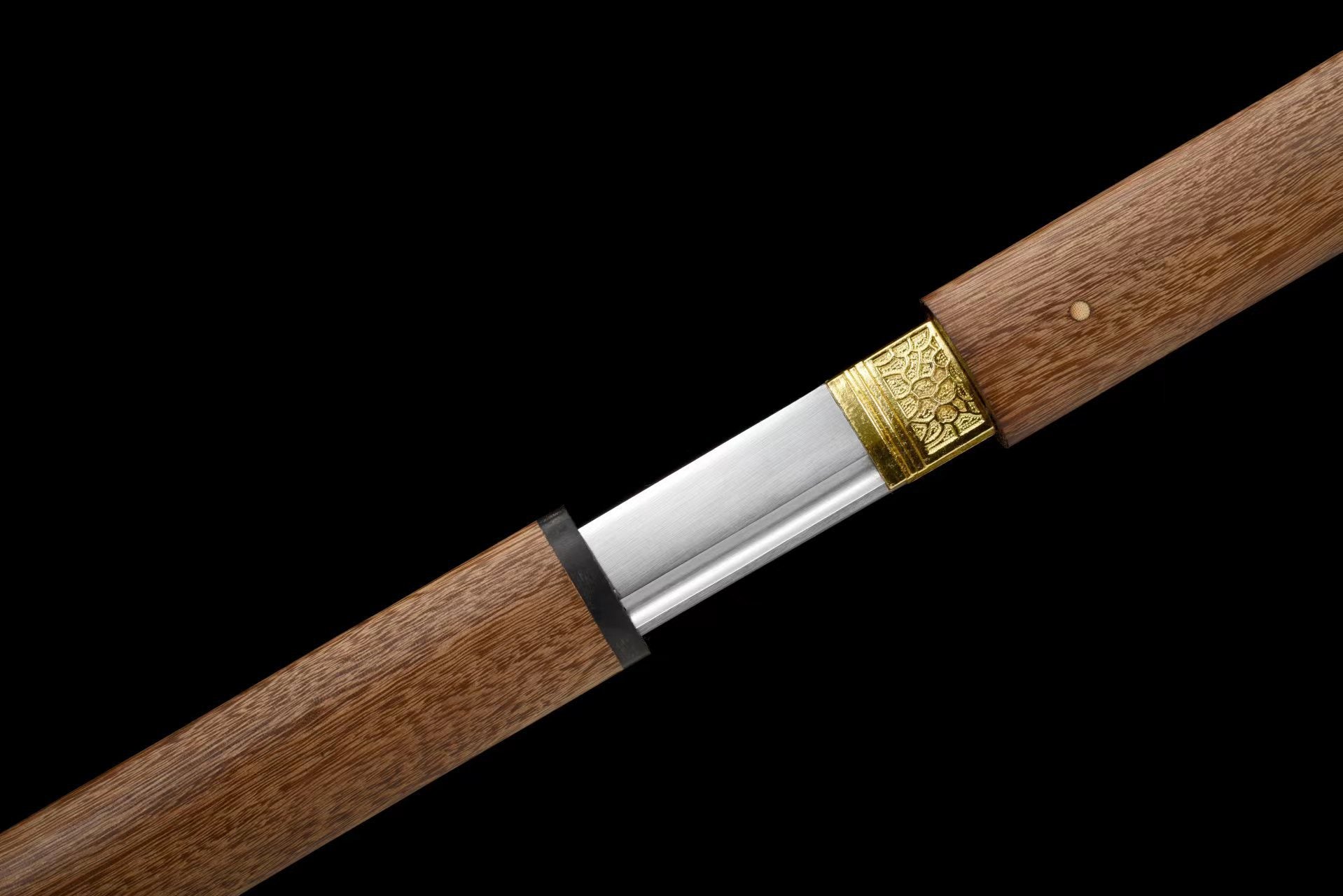 Close-up of Ebony Straight sword handle, gold-tone fitting, and grooved blade