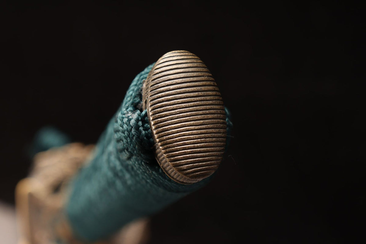 Ribbed antique-bronze-tone kashira on the deep teal wrapped tsuka
