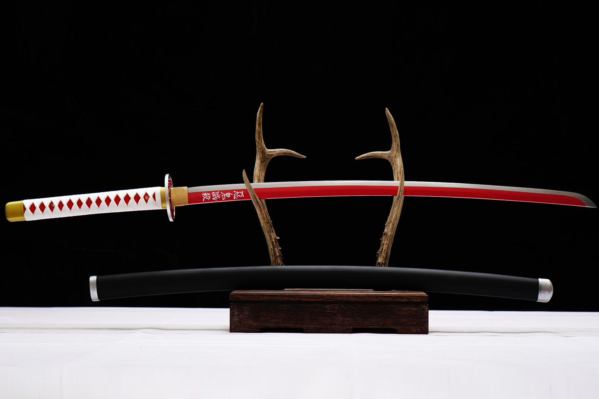 Full view of Kanao Tsuyuri Katana with red-and-white blade, white handle wrap, and black scabbard