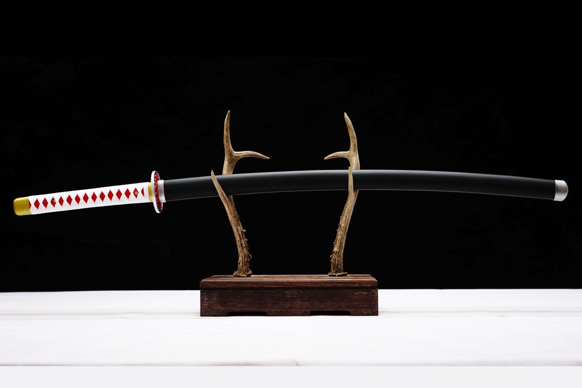 Full sheathed view of Kanao Tsuyuri Katana with white handle wrap and black scabbard
