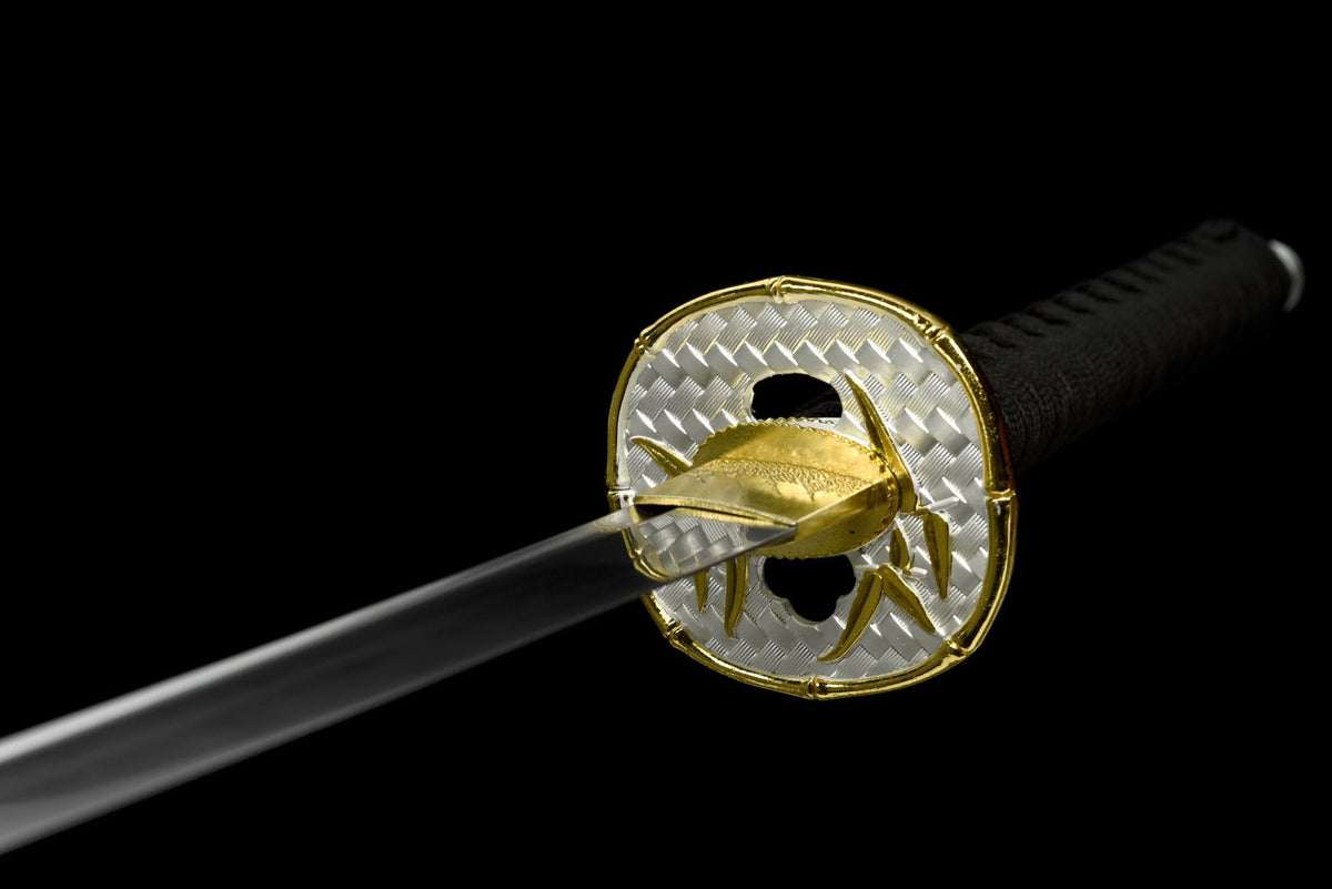 Silver and gold-toned tsuba with raised bamboo leaves
