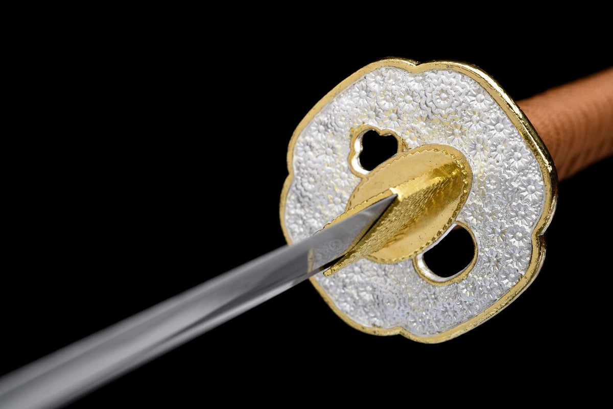 Silver floral mokko-gata tsuba with gold-toned rim