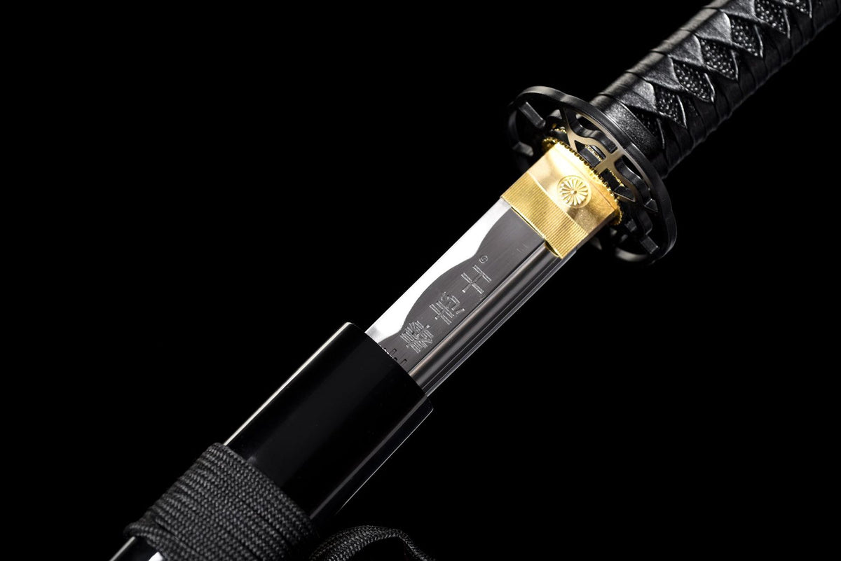 Gold-toned habaki with floral medallion and black tsuba