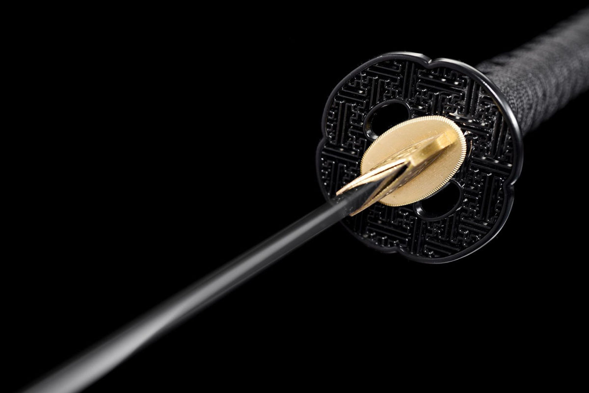 Black mokko-gata tsuba with a repeating sayagata geometric pattern