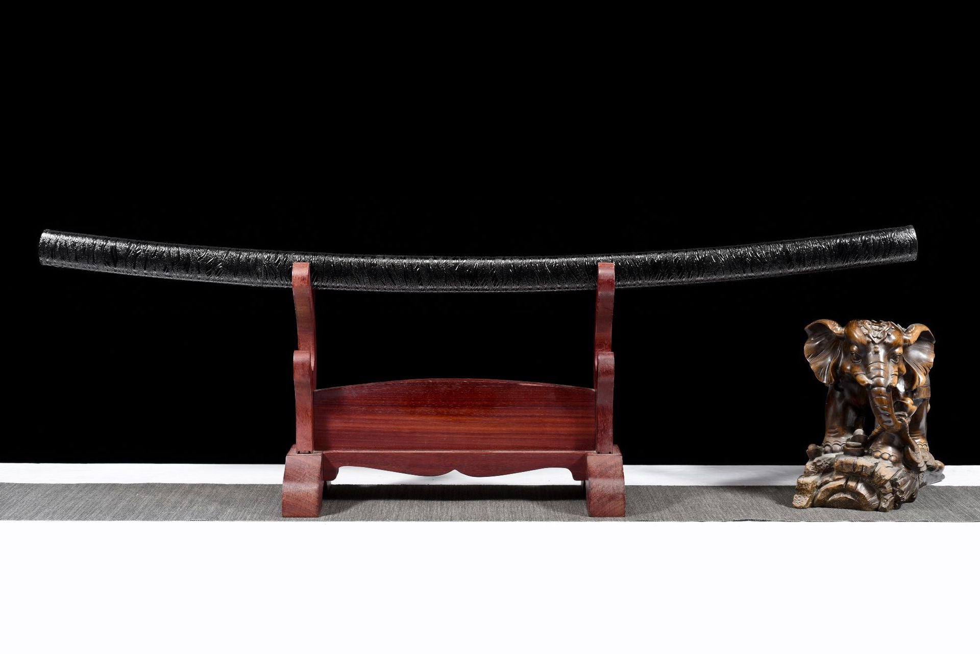 Shadow Bamboo Katana sheathed on a wooden sword stand