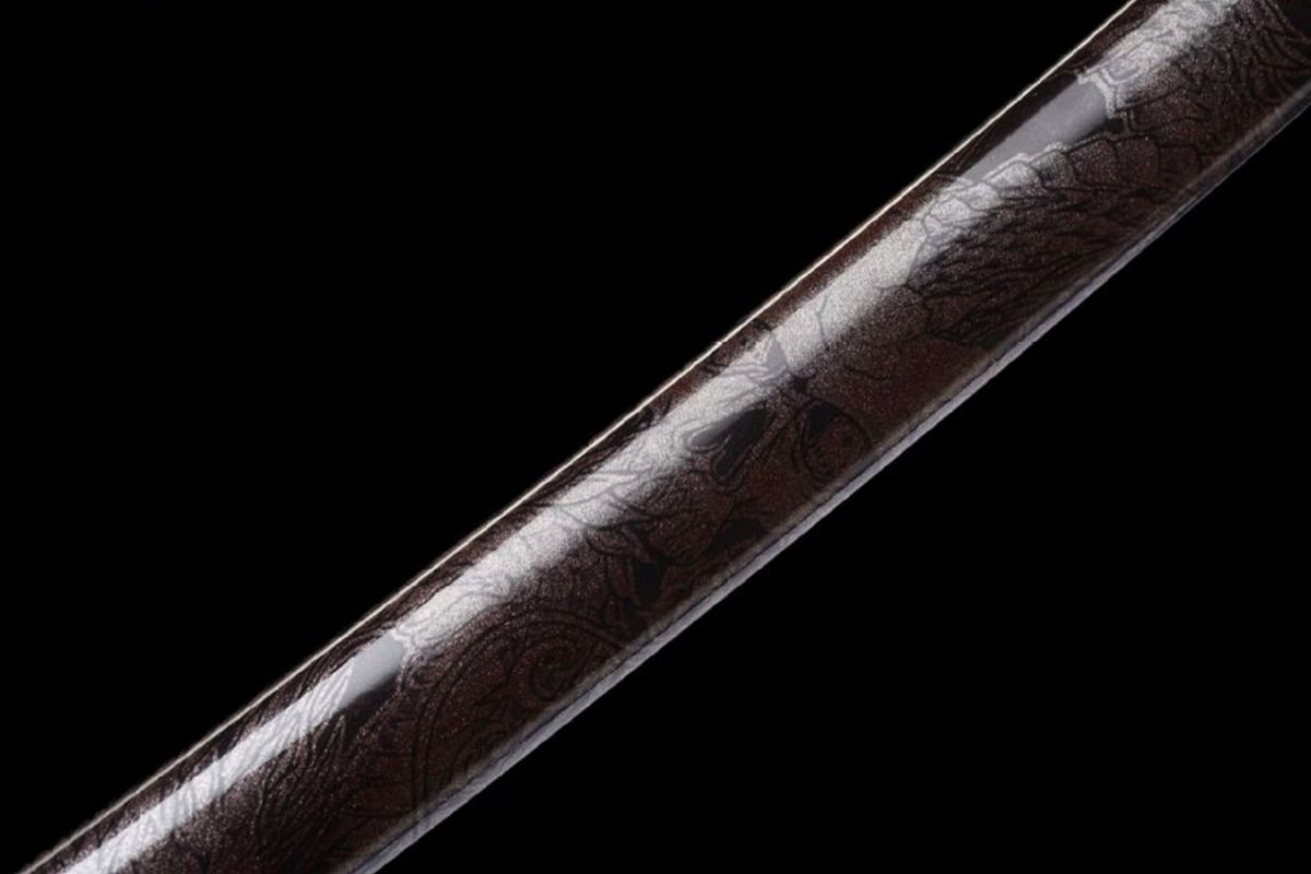 Dark floral linework on the brown lacquered saya