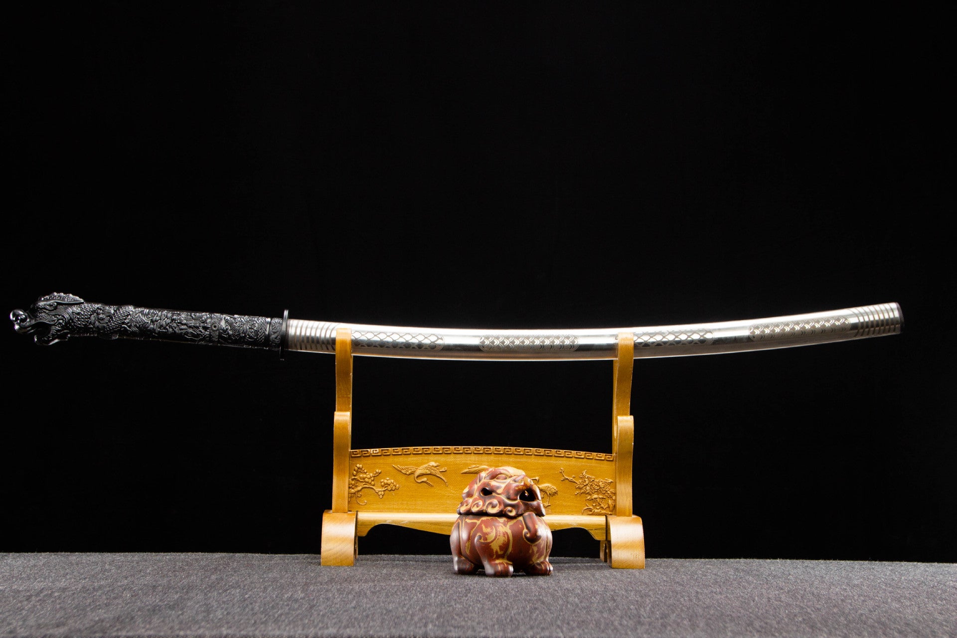 Silver Dragon Katana sheathed in its polished stainless steel saya
