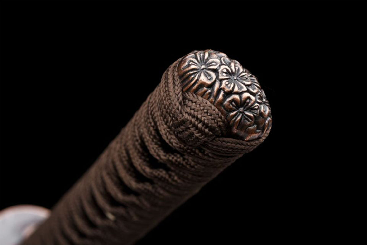 Floral relief kashira on the brown-wrapped tsuka