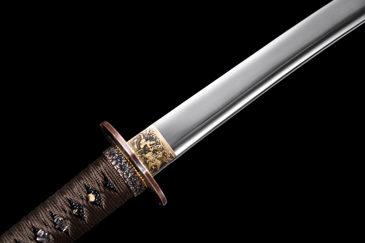 Patterned habaki and bo-hi at the base of the Six Masks Katana blade