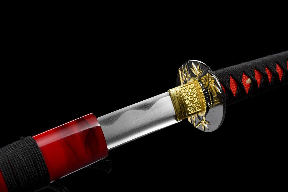 Handle detail with gold-toned menuki beneath black cord wrap