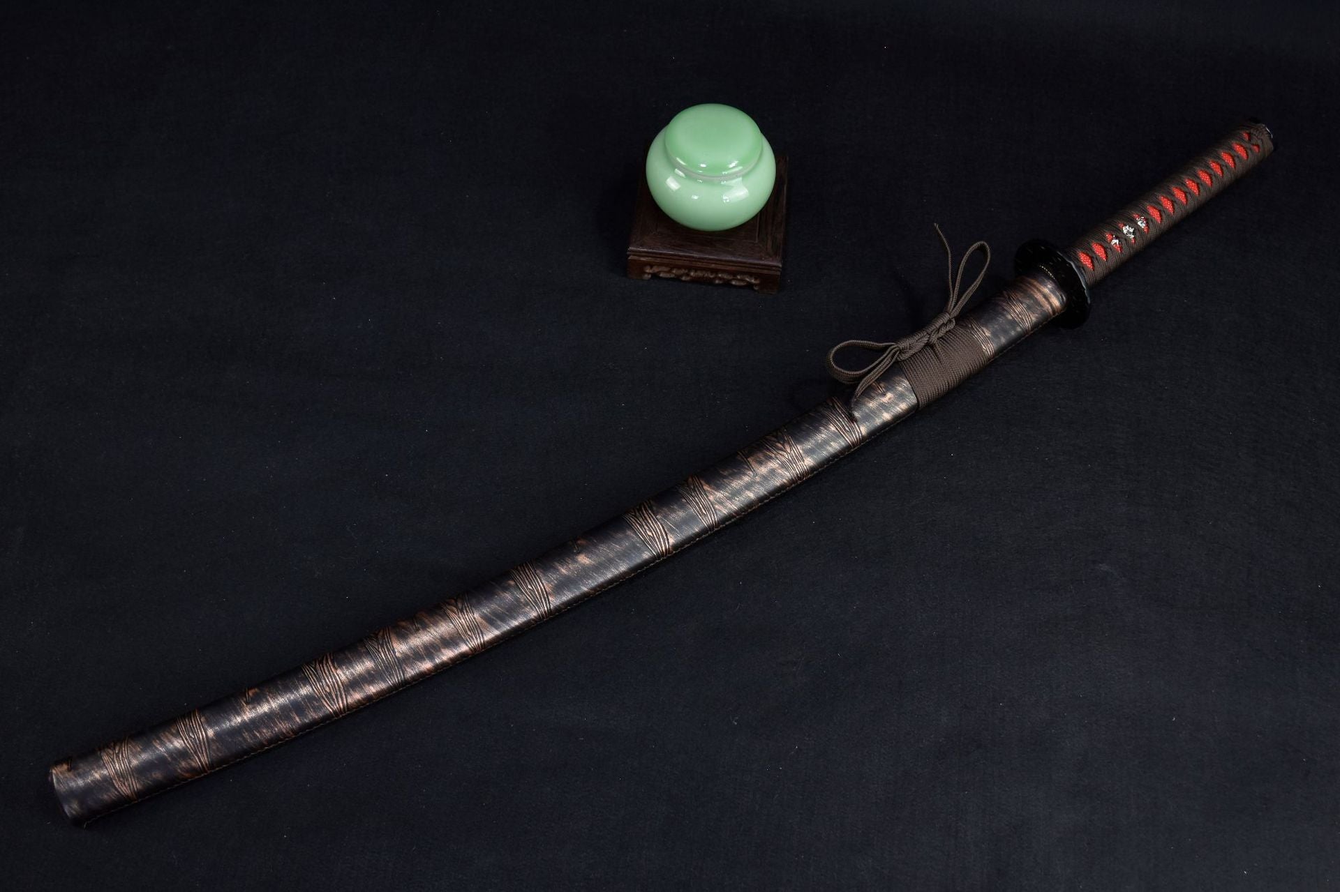 An authentic brown samurai sword on a black background available for purchase