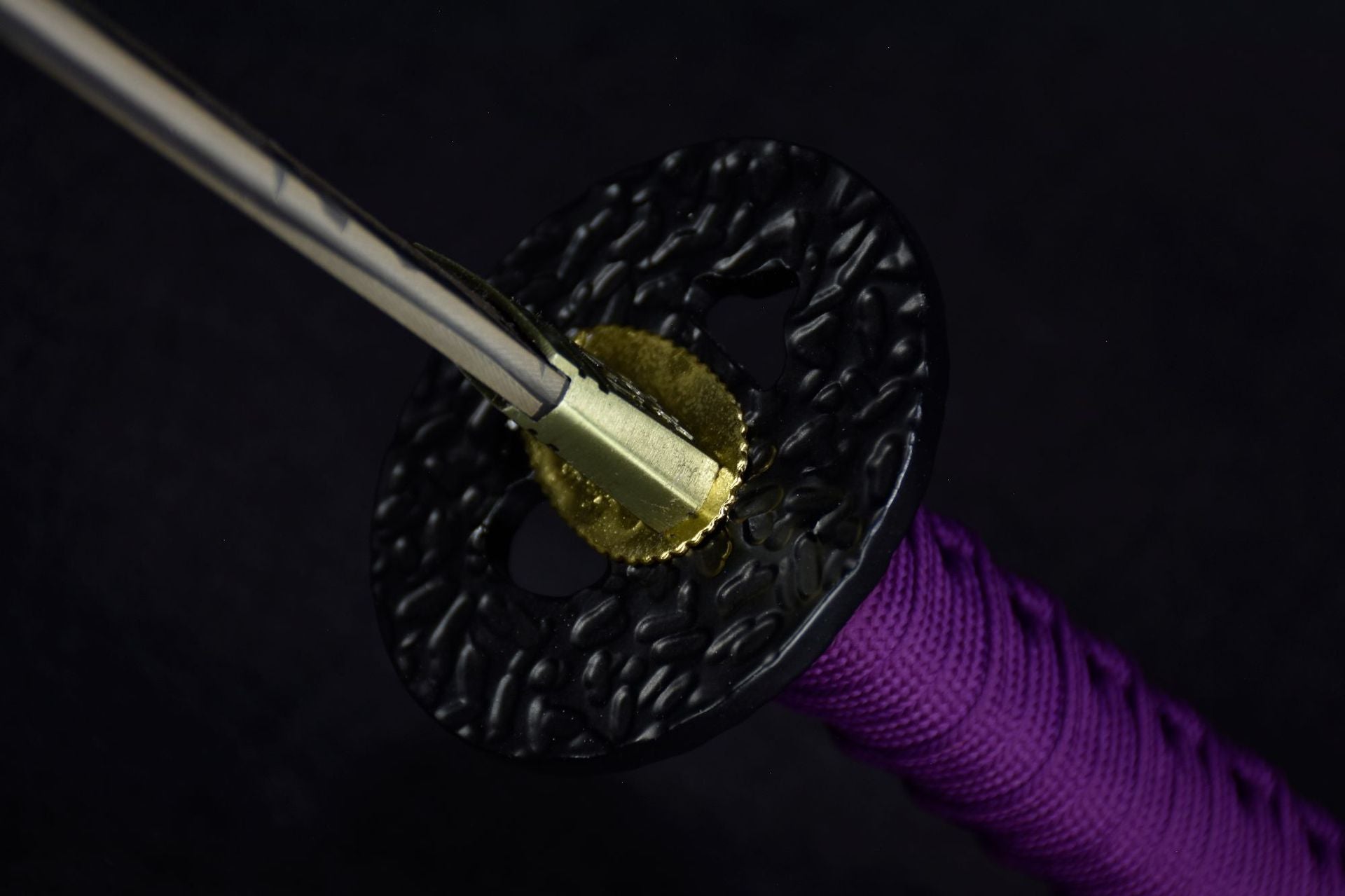 A black tsuba, a part featured on a samurai sword