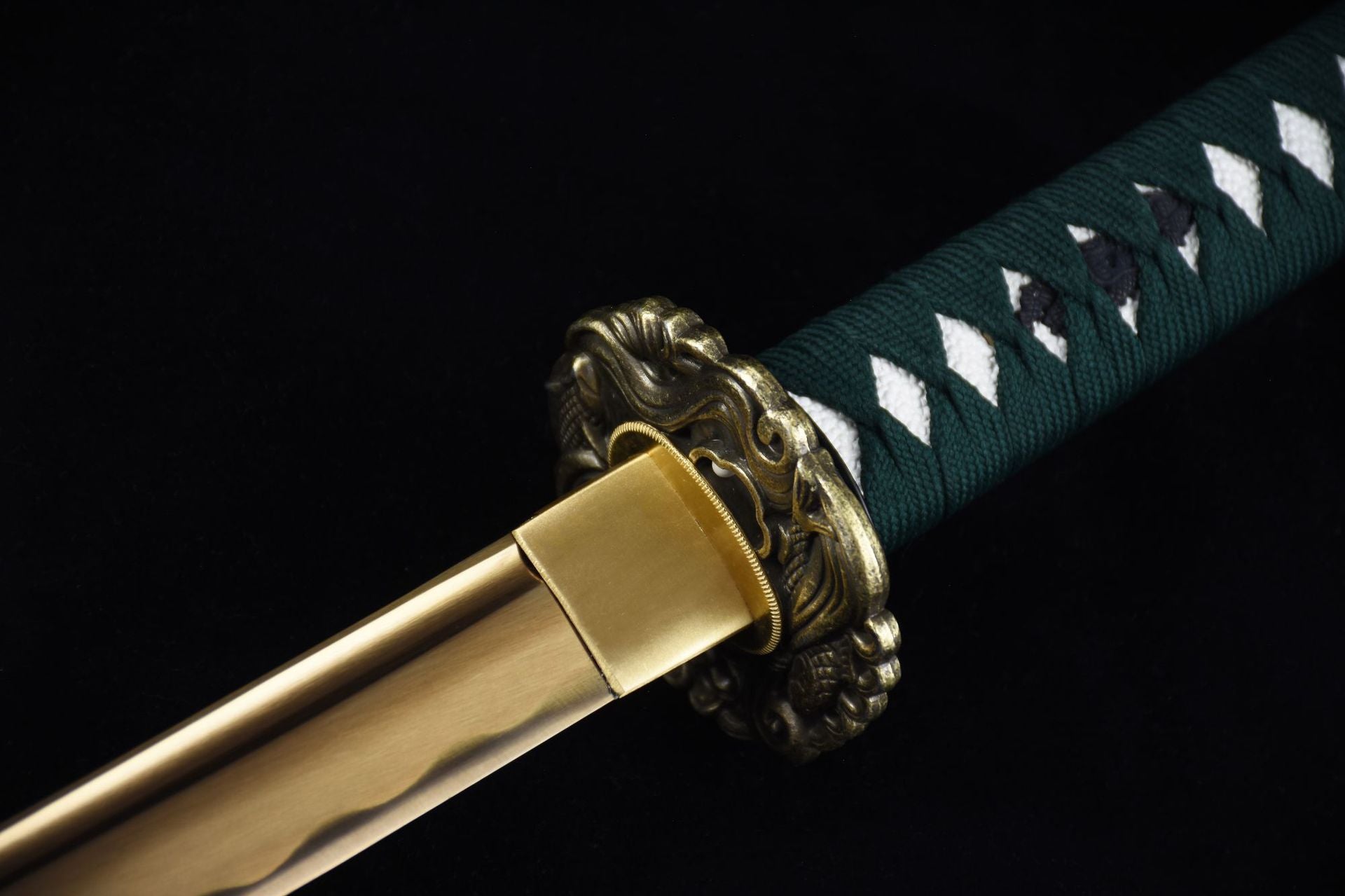 Close-up of a brass round tsuba on a samurai sword, highlighting its intricate design.