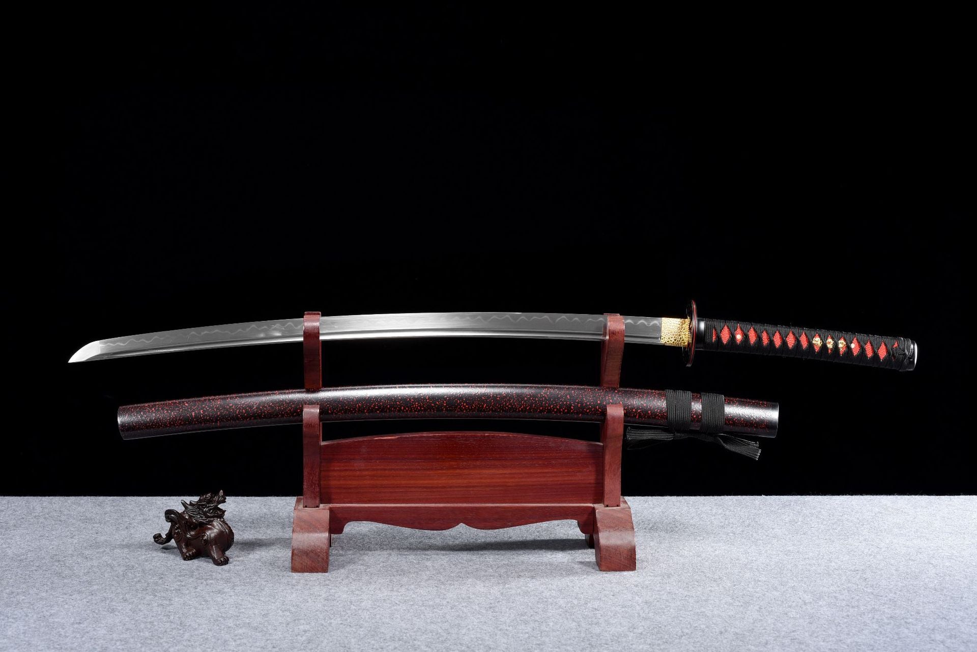 A brown-red clay-tempered carbon steel katana with a polished blade, showcasing traditional craftsmanship.